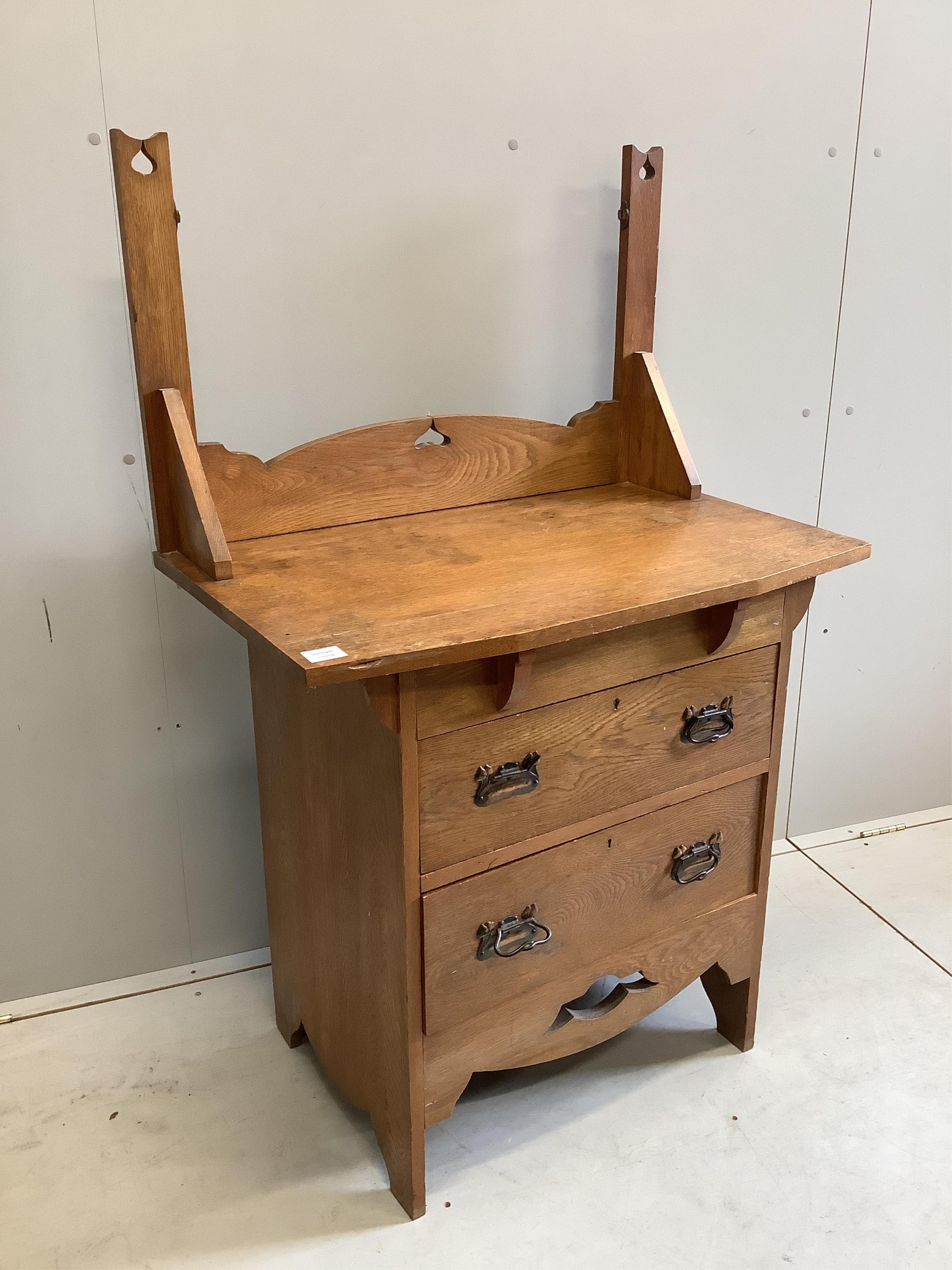 An Arts and Crafts oak dressing chest, (lacking mirror) width 84cm, depth 50cm, height 133cm